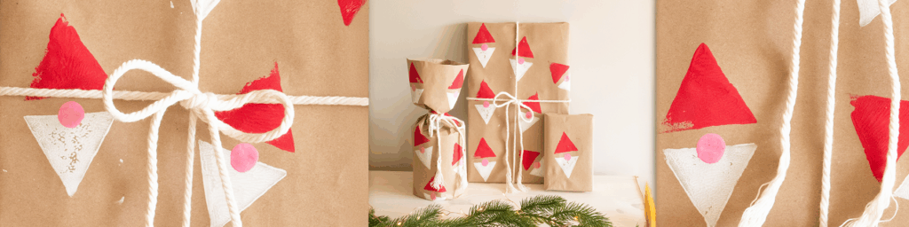 Brunpapirpakker med røde og hvite nissetrykk og hvitt tau.